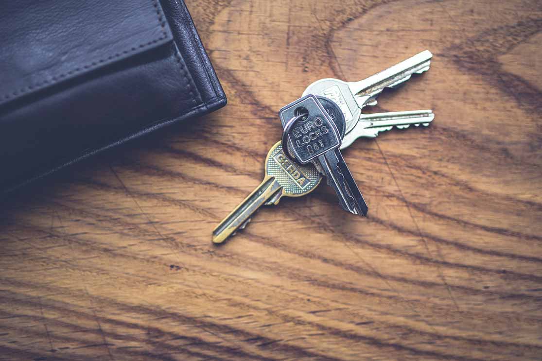 keys and wallet laying on wood