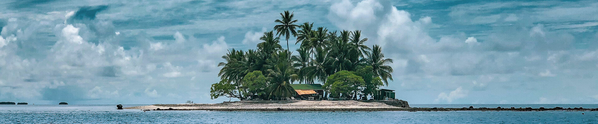 island in horizon surrounded by water